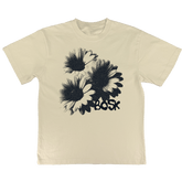 The BOSK Floret Tee is a cream heavyweight cotton t-shirt with a black stippled illustration of three overlapping daisies and "BOSK" in bold below. It offers an oversized fit and is available in men's sizing.